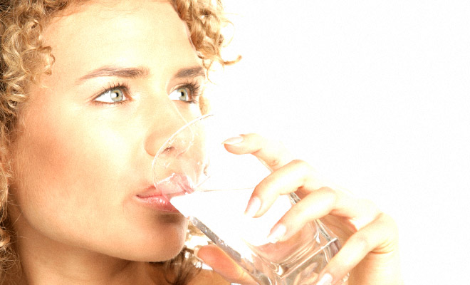 woman drinking a glass of water