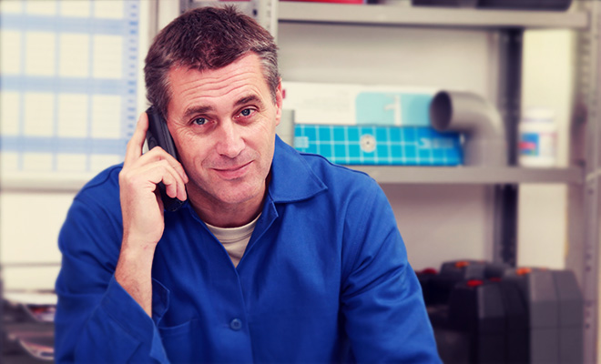 plumber answering phone call in his office