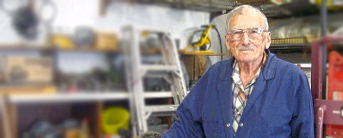 lorne figley, canada's oldest plumber, standing infront of some plumbing supplies